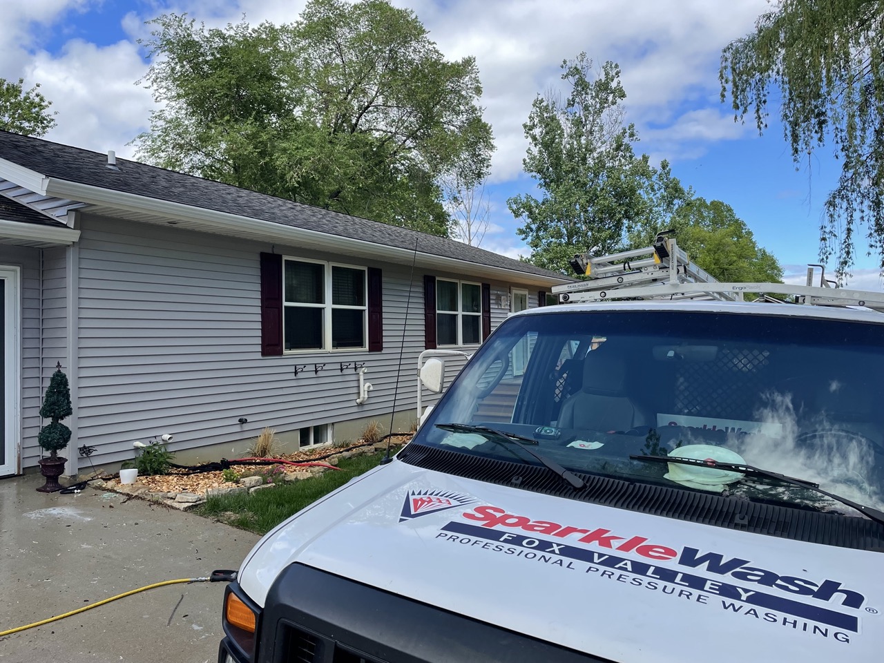 Sparkle Wash professional pressure washing van parked outside residential home in Fond du Lac, Wisconsin, ready for house exterior cleaning service