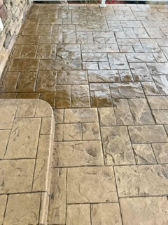 Concrete patio with geometric stone pattern after professional pressure washing in Fond du Lac, Wisconsin