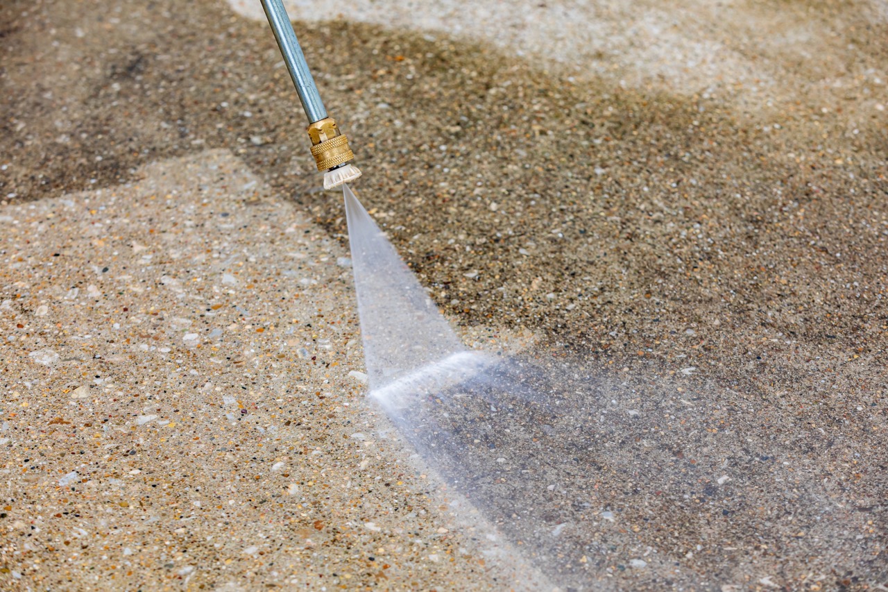 High-pressure water stream from washing nozzle cleaning concrete surface in Fond du Lac, Wisconsin