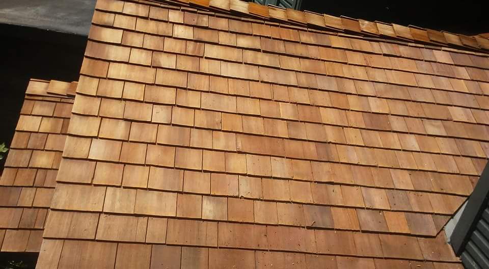 Cedar shake roof with weathered wooden shingles showing natural aging and discoloration, demonstrating need for professional roof cleaning service